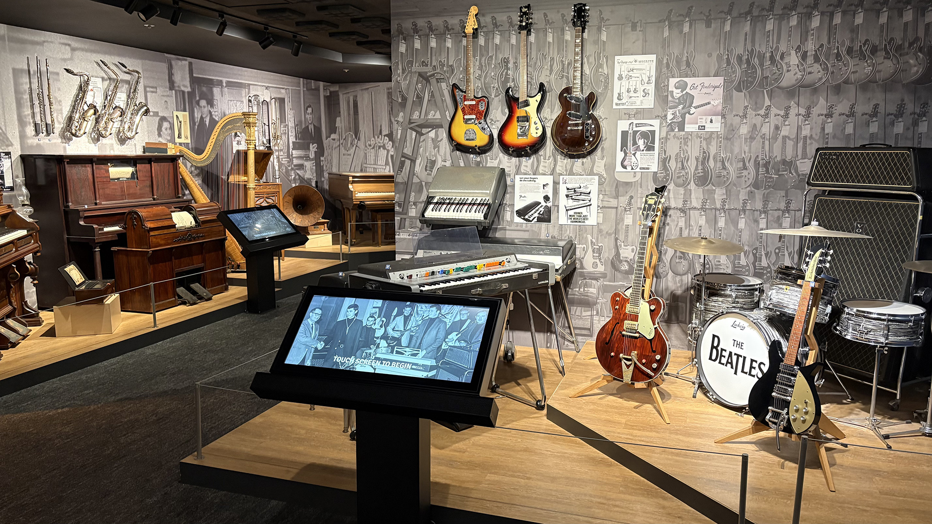 Vintage guitars, drums, and keyboards on display in a gallery at the Museum of Making Music.