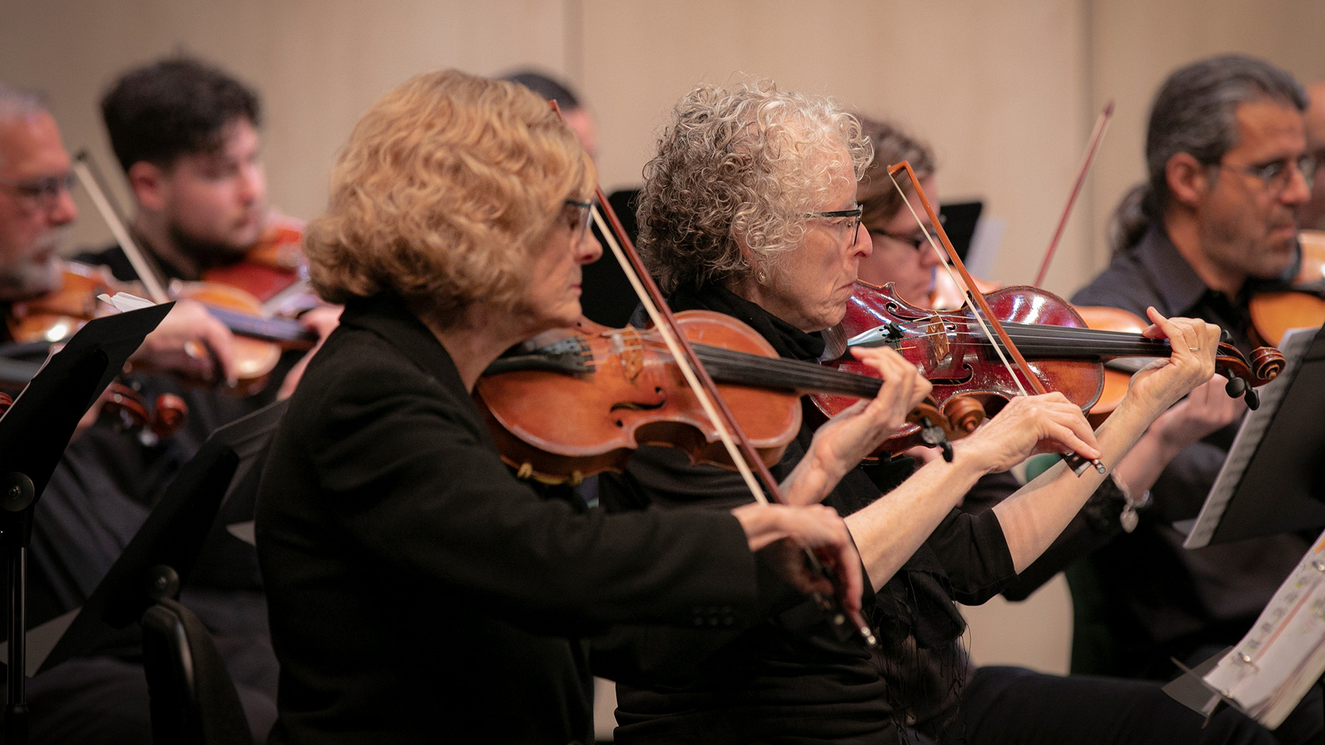 Violinists playing during a North Coast Strings concert