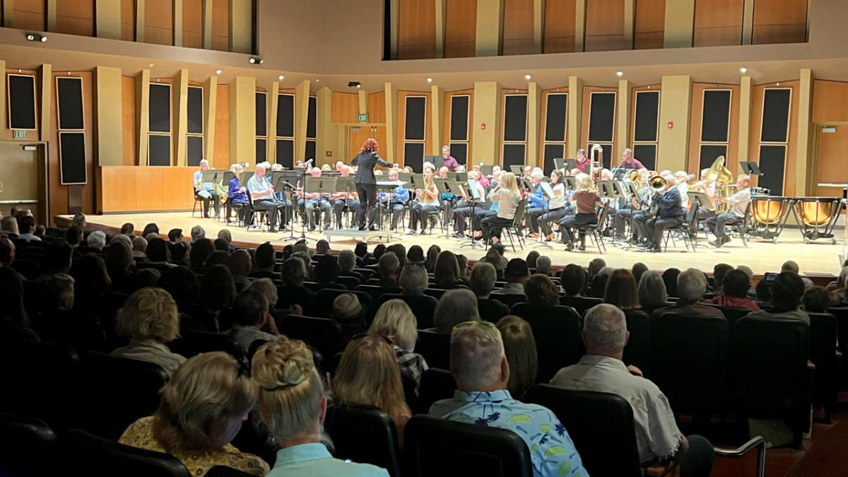 New Horizons Band on stage in a theater with a crowd watching