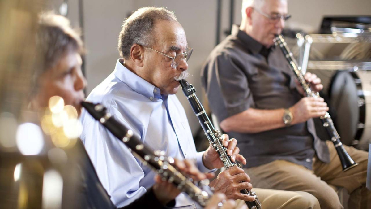 Three adult clarinet players performing together during a New Horizons Band rehearsal